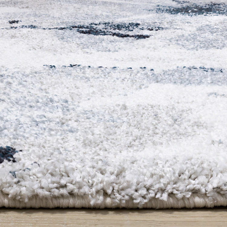 Alfombra gris sable con estampado floral azul crema de Kalora Interiors